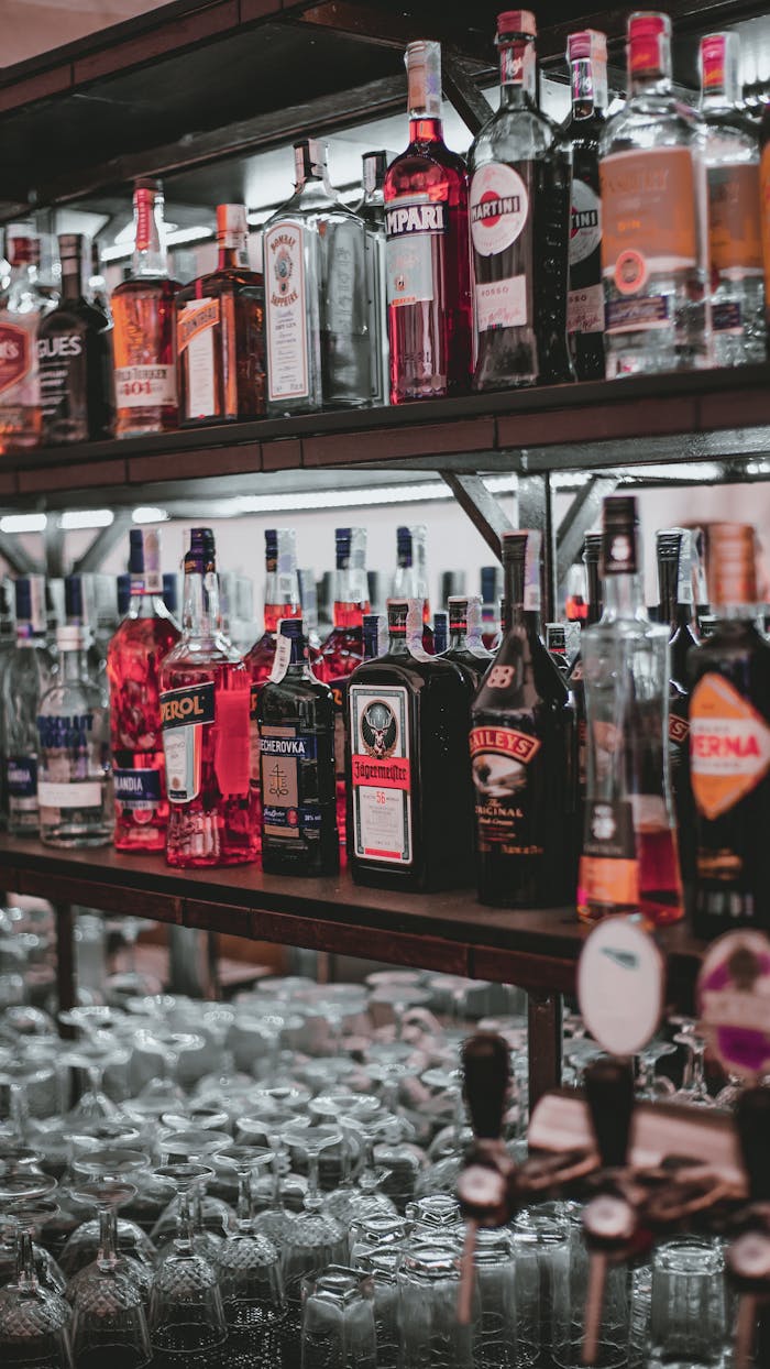 about-img A curated selection of diverse liquor bottles arranged on bar shelves for easy access.